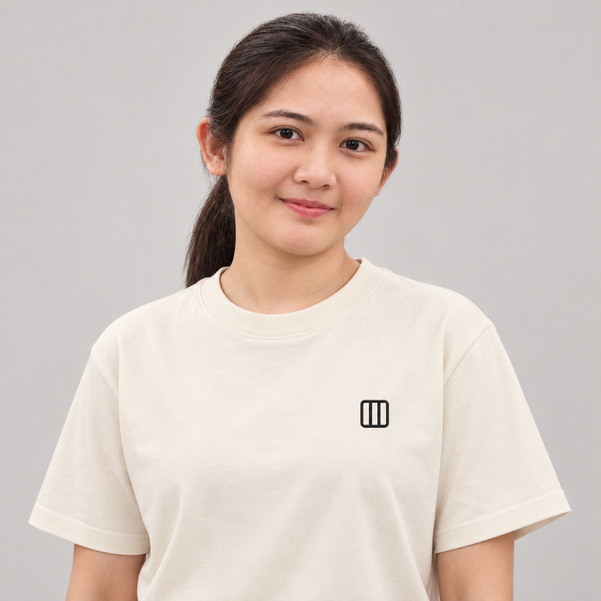 Architect Column Tee in cream with charcoal embroidered column icon
