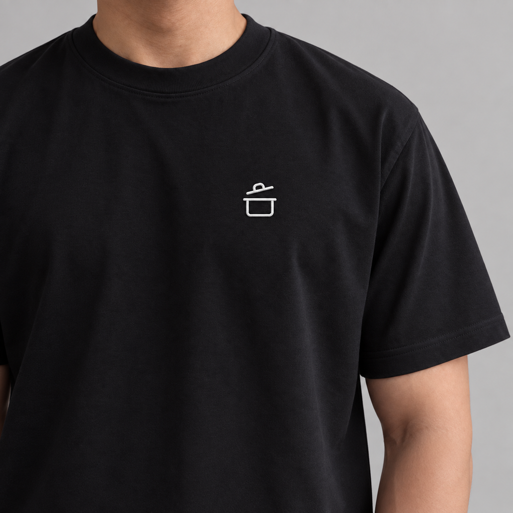 Chef Pan Tee in black with white embroidered cooking pot